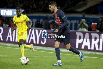 2023-12-09 - Achraf Hakimi of PSG, left Moses Simon of Nantes during the French championship Ligue 1 football match between Paris Saint-Germain and FC Nantes on December 9, 2023 at Parc des Princes stadium in Paris, France - FOOTBALL - FRENCH CHAMP - PARIS SG V NANTES - FRENCH LIGUE 1 - SOCCER