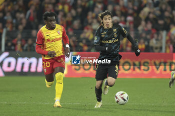 2023-12-16 - Junya Ito of Reims, left Faitout Maouassa of Lens during the French championship Ligue 1 football match between RC Lens ans Stade de Reims on December 16, 2023 at Bollaert-Delelis stadium in Lens, France - FOOTBALL - FRENCH CHAMP - LENS V REIMS - FRENCH LIGUE 1 - SOCCER