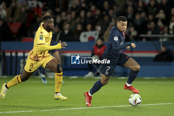 2023-12-20 - Kylian Mbappe of PSG, left Ismael Traore of Metz during the French championship Ligue 1 football match between Paris Saint-Germain and FC Metz on December 20, 2023 at Parc des Princes stadium in Paris, France - FOOTBALL - FRENCH CHAMP - PARIS SG V METZ - FRENCH LIGUE 1 - SOCCER