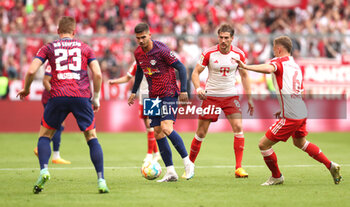 2023-05-20 - Andre Silva of RB Leipzig and Leon Goretzka, Joshua Kimmich of Bayern Munich during the German championship Bundesliga football match between Bayern Munich and RB Leipzig on May 20, 2023 at Allianz Arena in Munich, Germany - FOOTBALL - GERMAN CHAMP - BAYERN MUNICH V RB LEIPZIG - GERMAN BUNDESLIGA - SOCCER