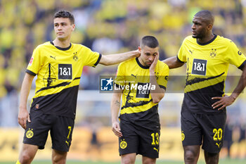 2023-05-27 - Giovanni Reyna, Raphael Guerreiro and Anthony Modeste of Borussia Dortmund look dejected after the German championship Bundesliga football match between Borussia Dortmund and FSV Mainz on May 27, 2023 at Signal Iduna Park in Dortmund, Germany - FOOTBALL - GERMAN CHAMP - DORTMUND V MAINZ - GERMAN BUNDESLIGA - SOCCER
