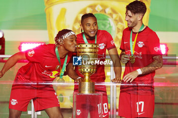2023-06-03 - Mohamed Simakan, Christopher Nkunku and Dominik Szoboszlai of RB Leipzig celebrate after winning the German Cup, Final football match between RB Leipzig and Eintracht Frankfurt on June 3, 2023 at Olympiastadion in Berlin, Germany - FOOTBALL - GERMAN CUP - FINAL - LEIPZIG V FRANKFURT - GERMAN BUNDESLIGA - SOCCER