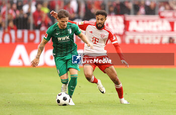2023-08-27 - Mads Pedersen of Augsburg and Noussair Mazraoui of Bayern Munich during the German championship Bundesliga football match between Bayern Munich and Augsburg on August 27, 2023 at Allianz Arena in Munich, Germany - FOOTBALL - GERMAN CHAMP - BAYERN MUNICH V AUGSBURG - GERMAN BUNDESLIGA - SOCCER