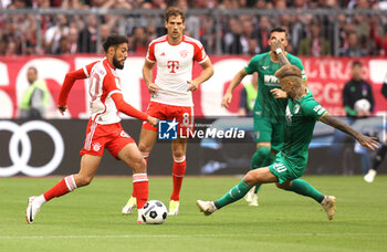 2023-08-27 - Noussair Mazraoui of Bayern Munich and Niklas Dorsch of Augsburg during the German championship Bundesliga football match between Bayern Munich and Augsburg on August 27, 2023 at Allianz Arena in Munich, Germany - FOOTBALL - GERMAN CHAMP - BAYERN MUNICH V AUGSBURG - GERMAN BUNDESLIGA - SOCCER