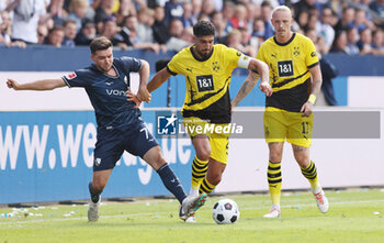 2023-08-26 - Kevin Stoger of Bochum and Emre Can of Borussia Dortmund during the German championship Bundesliga football match between VfL Bochum and Borussia Dortmund on August 26, 2023 at Vonovia Ruhrstadion in Bochum, Germany - FOOTBALL - GERMAN CHAMP - BOCHUM V BORUSSIA DORTMUND - GERMAN BUNDESLIGA - SOCCER