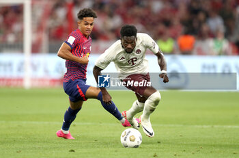 2023-08-12 - Alphonso Davies of Bayern Munich and Fabio Carvalho of RB Leipzig during the DFL Supercup 2023, German SuperCup football match between Bayern Munich and RB Leipzig on August 12, 2023 at Allianz Arena in Munich, Germany - FOOTBALL - GERMAN SUPERCUP - BAYERN MUNICH V RB LEIPZIG - GERMAN SUPERCUP - SOCCER