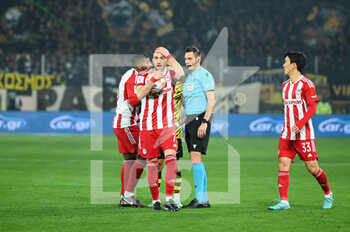 2023-03-12 - 7 KOSTAS FORTOUNIS of Olympiacos FC disagree with referee decision during the Greek Super League, Matchday 26, match between AEK FC and Olympiacos FC at OPAP Arena on March 12, 2023, in Athens, Greece. - AEK FC VS OLYMPIACOS FC - GREEK SUPER LEAGUE - SOCCER