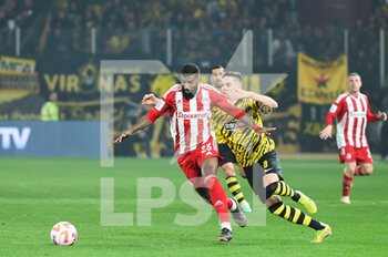 2023-03-12 - 23 RODINEI of Olympiacos FC competing with 8 MIJAT GAĆINOVIĆ of AEK FC during the Greek Super League, Matchday 26, match between AEK FC and Olympiacos FC at OPAP Arena on March 12, 2023, in Athens, Greece. - AEK FC VS OLYMPIACOS FC - GREEK SUPER LEAGUE - SOCCER