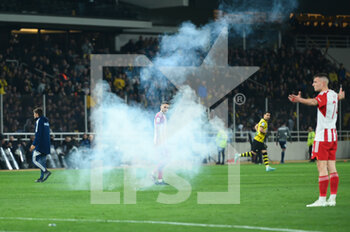 2023-03-12 - Smoke grenade near 7 KOSTAS FORTOUNIS of Olympiacos FC during the Greek Super League, Matchday 26, match between AEK FC and Olympiacos FC at OPAP Arena on March 12, 2023, in Athens, Greece. - AEK FC VS OLYMPIACOS FC - GREEK SUPER LEAGUE - SOCCER