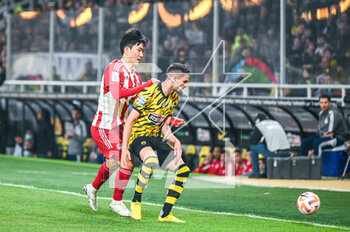 2023-05-03 - 8 MIJAT GAĆINOVIĆ of AEK FC competing with 33 INBEOM HWANG of Olympiacos FC during the Greek Super League, playoff match between AEK FC and Olympiacos FC at OPAP Arena on May 3, 2023, in Athens, Greece. - AEK VS OLYMPIACOS - GREEK SUPER LEAGUE - SOCCER