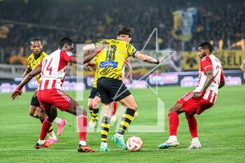 2023-05-03 - 10 STEVEN ZUBER of AEK FC competing with 24 OUSSEYNOU BA and 23 RODINEI of Olympiacos FC during the Greek Super League, playoff match between AEK FC and Olympiacos FC at OPAP Arena on May 3, 2023, in Athens, Greece. - AEK VS OLYMPIACOS - GREEK SUPER LEAGUE - SOCCER