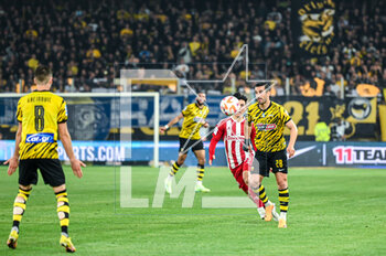2023-05-03 - 28 EHSAN HAJISAFI of AEK FC with 33 INBEOM HWANG of Olympiacos FC during the Greek Super League, playoff match between AEK FC and Olympiacos FC at OPAP Arena on May 3, 2023, in Athens, Greece. - AEK VS OLYMPIACOS - GREEK SUPER LEAGUE - SOCCER