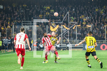 2023-05-03 - 21 DOMAGOJ VIDA of AEK FC competing with 94 CEDRIC BAKAMBU of Olympiacos FC during the Greek Super League, playoff match between AEK FC and Olympiacos FC at OPAP Arena on May 3, 2023, in Athens, Greece. - AEK VS OLYMPIACOS - GREEK SUPER LEAGUE - SOCCER