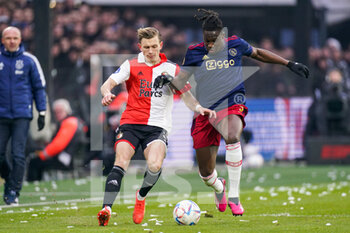 2023-01-22 - Marcus Pedersen of Feyenoord is challenged by Calvin Bassey of Ajax during the Netherlands championship Eredivisie football match between Feyenoord and Ajax on January 22, 2023 at Stadion Feijenoord in Rotterdam, Netherlands - FOOTBALL - NETHERLANDS CHAMP - FEYENOORD V AJAX - NETHERLANDS EREDIVISIE - SOCCER