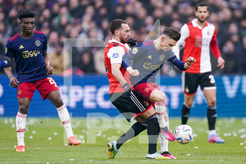 2023-01-22 - Orkun Kokcu of Feyenoord battles for the ball with Francisco Conceicao of Ajax during the Netherlands championship Eredivisie football match between Feyenoord and Ajax on January 22, 2023 at Stadion Feijenoord in Rotterdam, Netherlands - FOOTBALL - NETHERLANDS CHAMP - FEYENOORD V AJAX - NETHERLANDS EREDIVISIE - SOCCER