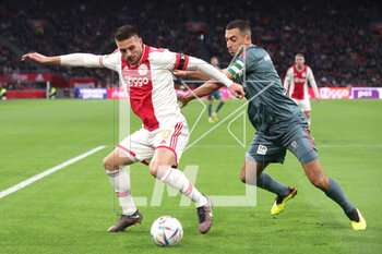 2023-02-19 - Dusan Tadic of Ajax, Adil Auassar of Sparta Rotterdam during the Netherlands championship Eredivisie football match between Ajax and Sparta Rotterdam on February 19, 2023 at Johan Cruijff ArenA in Amsterdam, Netherlands - FOOTBALL - NETHERLANDS CHAMP - AJAX V SPARTA ROTTERDAM - NETHERLANDS EREDIVISIE - SOCCER