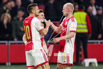 2023-04-16 - Dusan Tadic of Ajax celebrates his goal 3-1 with Francisco Conceicao, Davy Klaassen during the Netherlands championship Eredivisie football match between Ajax and FC Emmen on April 16, 2023 at Johan Cruijff ArenA in Amsterdam, Netherlands - FOOTBALL - NETHERLANDS CHAMP - AJAX V EMMEN - NETHERLANDS EREDIVISIE - SOCCER