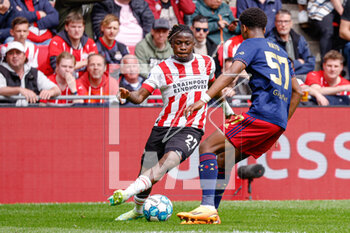 2023-04-23 - Johan Bakayoko of PSV, Jorrel Hato of Ajax during the Netherlands championship Eredivisie football match between PSV and Ajax on April 23, 2023 at Philips Stadion in Eindhoven, Netherlands - FOOTBALL - NETHERLANDS CHAMP - PSV V AJAX - NETHERLANDS EREDIVISIE - SOCCER