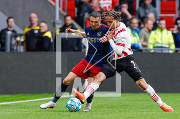 2023-04-23 - Steven Berghuis of Ajax battle for possession with Xavi Simons of PSV during the Netherlands championship Eredivisie football match between PSV and Ajax on April 23, 2023 at Philips Stadion in Eindhoven, Netherlands - FOOTBALL - NETHERLANDS CHAMP - PSV V AJAX - NETHERLANDS EREDIVISIE - SOCCER