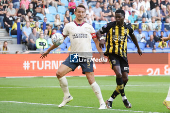 2023-08-19 - Luuk de Jong of PSV battles for the ball with Nicolas Isimat-Mirin of Vitesse during the Netherlands championship Eredivisie football match between Vitesse and PSV on August 19, 2023 at GelreDome in Arnhem, Netherlands - FOOTBALL - NETHERLANDS CHAMP - VITESSE V PSV - NETHERLANDS EREDIVISIE - SOCCER