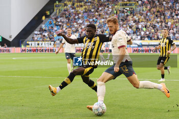 2023-08-19 - Carlens Arcus of Vitesse battles for the ball with Yorbe Vertessen of PSV during the Netherlands championship Eredivisie football match between Vitesse and PSV on August 19, 2023 at GelreDome in Arnhem, Netherlands - FOOTBALL - NETHERLANDS CHAMP - VITESSE V PSV - NETHERLANDS EREDIVISIE - SOCCER