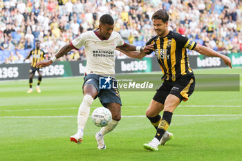 2023-08-19 - Patrick van Aanholt of PSV battles for the ball with Marco van Ginkel of Vitesse during the Netherlands championship Eredivisie football match between Vitesse and PSV on August 19, 2023 at GelreDome in Arnhem, Netherlands - FOOTBALL - NETHERLANDS CHAMP - VITESSE V PSV - NETHERLANDS EREDIVISIE - SOCCER