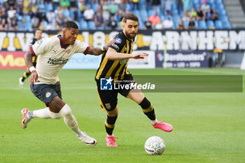 2023-08-19 - Patrick van Aanholt of PSV battles for the ball with Said Hamulic of Vitesse during the Netherlands championship Eredivisie football match between Vitesse and PSV on August 19, 2023 at GelreDome in Arnhem, Netherlands - FOOTBALL - NETHERLANDS CHAMP - VITESSE V PSV - NETHERLANDS EREDIVISIE - SOCCER