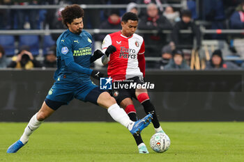 2023-12-03 - Marcos Lopez of Feyenoord battles for the ball with Andre Ramalho of PSV during the Netherlands championship Eredivisie football match between Feyenoord and PSV on December 3, 2023 at Stadion Feijenoord in Rotterdam, Netherlands - FOOTBALL - NETHERLANDS CHAMP - FEYENOORD V PSV - NETHERLANDS EREDIVISIE - SOCCER