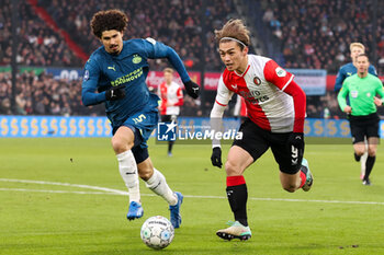 2023-12-03 - Ayase Ueda of Feyenoord is challenged by Andre Ramalho of PSV during the Netherlands championship Eredivisie football match between Feyenoord and PSV on December 3, 2023 at Stadion Feijenoord in Rotterdam, Netherlands - FOOTBALL - NETHERLANDS CHAMP - FEYENOORD V PSV - NETHERLANDS EREDIVISIE - SOCCER