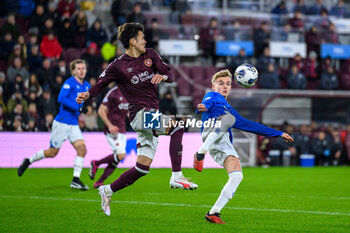 2023-12-06 - Ross McCausland of Rangers and Kyosuke Tagawa of Hearts during the Scottish championship Premiership football match between Heart of Midlothian and Rangers on 6 December 2023 at Tynecastle Park in Edinburgh, Scotland - FOOTBALL - SCOTTISH CHAMP - HEART OF MIDLOTHIAN V RANGERS - SCOTTISH PREMIERSHIP - SOCCER