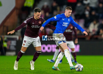 2023-12-06 - John Lundstram of Rangers and Lawrence Shankland of Hearts during the Scottish championship Premiership football match between Heart of Midlothian and Rangers on 6 December 2023 at Tynecastle Park in Edinburgh, Scotland - FOOTBALL - SCOTTISH CHAMP - HEART OF MIDLOTHIAN V RANGERS - SCOTTISH PREMIERSHIP - SOCCER