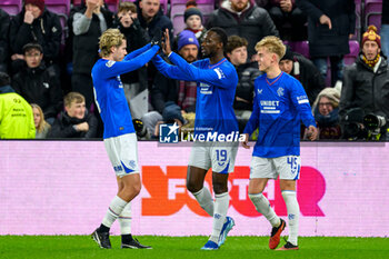 2023-12-06 - Abdallah Sima of Rangers celebrates his goal 0-1 with Todd Cantwell and Ross McCausland during the Scottish championship Premiership football match between Heart of Midlothian and Rangers on 6 December 2023 at Tynecastle Park in Edinburgh, Scotland - FOOTBALL - SCOTTISH CHAMP - HEART OF MIDLOTHIAN V RANGERS - SCOTTISH PREMIERSHIP - SOCCER
