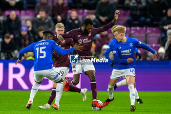 2023-12-06 - Beni Baningime of Hearts and Jose Cifuentes, Ross McCausland of Rangers during the Scottish championship Premiership football match between Heart of Midlothian and Rangers on 6 December 2023 at Tynecastle Park in Edinburgh, Scotland - FOOTBALL - SCOTTISH CHAMP - HEART OF MIDLOTHIAN V RANGERS - SCOTTISH PREMIERSHIP - SOCCER