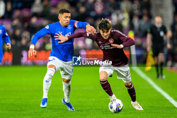 2023-12-06 - Kyosuke Tagawa of Hearts and James Tavernier of Rangers during the Scottish championship Premiership football match between Heart of Midlothian and Rangers on 6 December 2023 at Tynecastle Park in Edinburgh, Scotland - FOOTBALL - SCOTTISH CHAMP - HEART OF MIDLOTHIAN V RANGERS - SCOTTISH PREMIERSHIP - SOCCER
