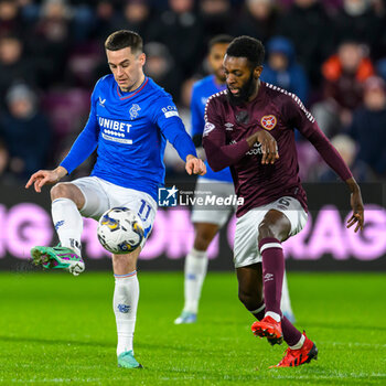 2023-12-06 - Tom Lawrence of Rangers and Beni Baningime of Hearts during the Scottish championship Premiership football match between Heart of Midlothian and Rangers on 6 December 2023 at Tynecastle Park in Edinburgh, Scotland - FOOTBALL - SCOTTISH CHAMP - HEART OF MIDLOTHIAN V RANGERS - SCOTTISH PREMIERSHIP - SOCCER
