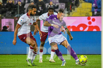 2023-01-21 - Fiorentina's Cristiano Biraghi hampered by Torino's Koffi Djidji - ACF FIORENTINA VS TORINO FC - ITALIAN SERIE A - SOCCER