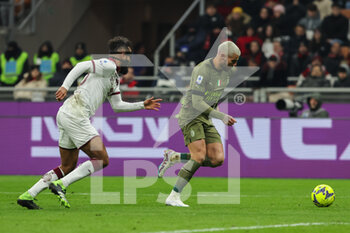 2023-02-10 - Theo Hernandez of AC Milan competes for the ball with Koffi Djidji of Torino FC during Serie A 2022/23 football match between AC Milan and Torino FC at San Siro Stadium, Milan, Italy on February 10, 2023 - AC MILAN VS TORINO FC - ITALIAN SERIE A - SOCCER