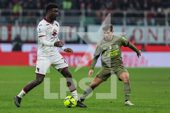 2023-02-10 - Ndary Adopo of Torino FC in action with Brahim Diaz of AC Milan during Serie A 2022/23 football match between AC Milan and Torino FC at San Siro Stadium, Milan, Italy on February 10, 2023 - AC MILAN VS TORINO FC - ITALIAN SERIE A - SOCCER