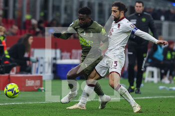 2023-02-10 - Divock Origi of AC Milan competes for the ball with Ricardo Rodriguez of Torino FC during Serie A 2022/23 football match between AC Milan and Torino FC at San Siro Stadium, Milan, Italy on February 10, 2023 - AC MILAN VS TORINO FC - ITALIAN SERIE A - SOCCER