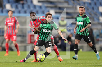 2023-03-06 - Maxime López of U.S. Sassuolo Calcio competes for the ball with Felix Afena-Gyan of U.S. Cremonese during the Serie A match between U.S. Sassuolo Calcio and US Cremonese at Mapei Stadium-Città del Tricolore on March 6, 2023 in Reggio Emilia, Italy. - US SASSUOLO VS US CREMONESE - ITALIAN SERIE A - SOCCER