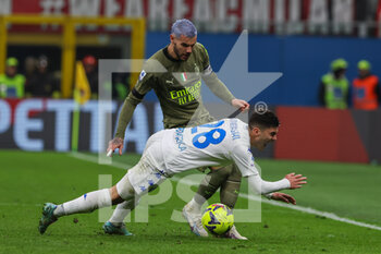 2023-04-07 - Theo Hernandez of AC Milan competes for the ball with Nicolo Cambiaghi of Empoli FC during Serie A 2022/23 football match between AC Milan and Empoli FC at San Siro Stadium, Milan, Italy on April 07, 2023 - AC MILAN VS EMPOLI FC - ITALIAN SERIE A - SOCCER