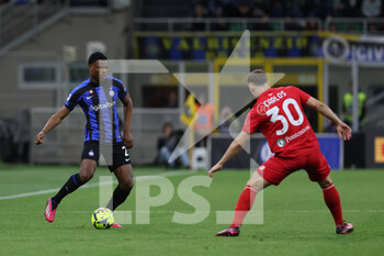 2023-04-15 - Denzel Dumfries of FC Internazionale in action with Carlos Augusto of AC Monza during Serie A 2022/23 football match between FC Internazionale and AC Monza at Giuseppe Meazza Stadium, Milan, Italy on April 15, 2023 - INTER - FC INTERNAZIONALE VS AC MONZA - ITALIAN SERIE A - SOCCER