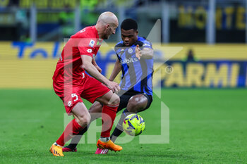 2023-04-15 - Luca Caldirola of AC Monza competes for the ball with Denzel Dumfries of FC Internazionale during Serie A 2022/23 football match between FC Internazionale and AC Monza at Giuseppe Meazza Stadium, Milan, Italy on April 15, 2023 - INTER - FC INTERNAZIONALE VS AC MONZA - ITALIAN SERIE A - SOCCER
