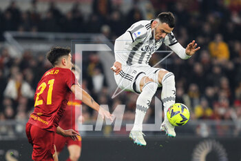 2023-03-05 - Filip Kostic of Juventus (R) kicks the ball during the Italian championship Serie A football match between AS Roma and Juventus FC on March 5, 2023 at Stadio Olimpico in Rome, Italy - FOOTBALL - ITALIAN CHAMP - ROMA V JUVENTUS - ITALIAN SERIE A - SOCCER