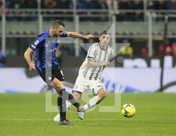 2023-03-19 - Stefan de Vrij of FC Internazionale and Leandro Paredes of Juventus during the Italian Serie A football match between Fc Internazionale and Juventus Fc, on 19 March 2023 at Stadio Giuseppe Meazza, San Siro, Milan, Italy. Photo Nderim Kaceli - INTER - FC INTERNAZIONALE VS JUVENTUS FC - ITALIAN SERIE A - SOCCER