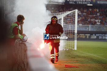2023-08-19 - Fireman removing fireworks from the pitch during the Italian Serie A, football match between Genoa Cfc and Acf Fiorentina on 19 August 2023 at Luigi Ferraris stadium, Genova Italy. Photo Nderim KACELI - GENOA CFC VS ACF FIORENTINA - ITALIAN SERIE A - SOCCER