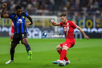 2023-08-19 - Georgios Kyriakopoulos of AC Monza competes for the ball with Denzel Dumfries of FC Internazionale during Serie A 2023/24 football match between FC Internazionale and AC Monza at Giuseppe Meazza Stadium, Milan, Italy on August 19, 2023 - INTER - FC INTERNAZIONALE VS AC MONZA - ITALIAN SERIE A - SOCCER