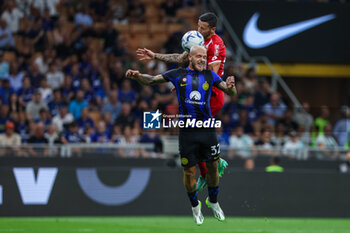 2023-08-19 - Federico Dimarco of FC Internazionale competes for the ball with Patrick Ciurria of AC Monza during Serie A 2023/24 football match between FC Internazionale and AC Monza at Giuseppe Meazza Stadium, Milan, Italy on August 19, 2023 - INTER - FC INTERNAZIONALE VS AC MONZA - ITALIAN SERIE A - SOCCER