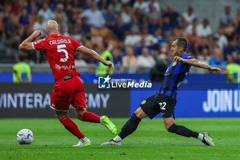 2023-08-19 - Henrikh Mkhitaryan of FC Internazionale competes for the ball with Luca Caldirola of AC Monza during Serie A 2023/24 football match between FC Internazionale and AC Monza at Giuseppe Meazza Stadium, Milan, Italy on August 19, 2023 - INTER - FC INTERNAZIONALE VS AC MONZA - ITALIAN SERIE A - SOCCER