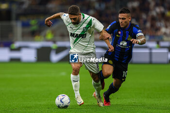 2023-09-27 - Domenico Berardi of US Sassuolo competes for the ball with Lautaro Martinez of FC Internazionale during Serie A 2023/24 football match between FC Internazionale and US Sassuolo at Giuseppe Meazza Stadium, Milan, Italy on September 27, 2023 - INTER - FC INTERNAZIONALE VS US SASSUOLO - ITALIAN SERIE A - SOCCER